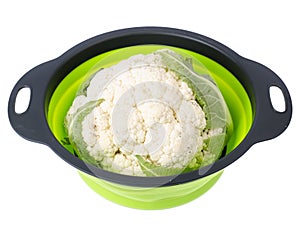 Head of fresh cauliflower in colander on white background