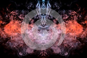The head of a ghost on a black background from a smoke pattern of an orange-colored vape vaporizing like flame
