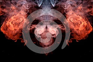 The head of a ghost on a black background from a smoke pattern of an orange-colored vape vaporizing photo