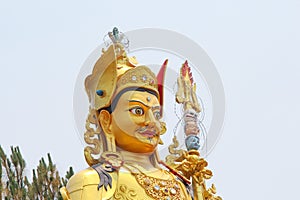 Head of golden Guru Rinpoche statue