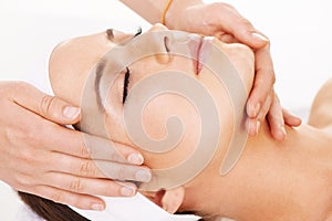 Head, hands and massage with a woman customer in studio isolated on a white background for stress relief. Spa, luxury