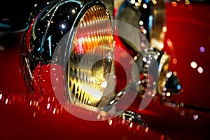 Head lamp detail of red antique car photo