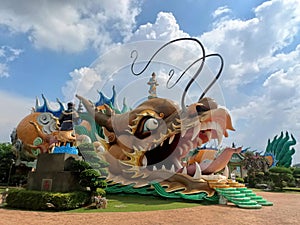 Head with large mouth tongue opening as entrance, body long & tail of Fortune or Prosperity Dragon Chinese Temple at Yong Peng, Jo