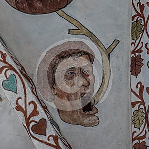 Head and mouth of a man painted around a vent, an ancient mural