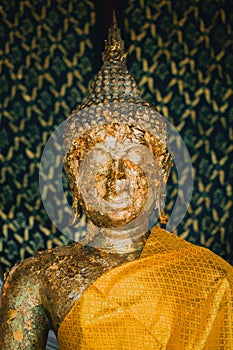 Head of old golden Buddha image in Thailand temple.