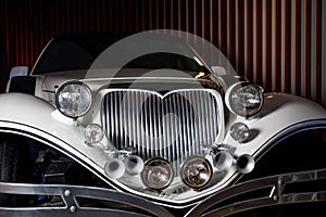The head of an old retro car. Headlights and radiator grid. photo