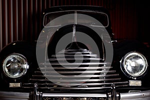 The head of an old retro car. Headlights and radiator grid. photo
