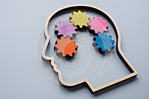 Head outline and colored gears as a concept for lateral thinking, creativity and neurodiversity.