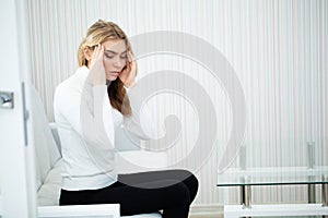 Head pain. Young woman keeping hand on her head