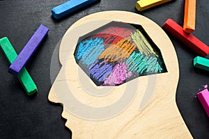 The head is painted with colored crayons. Neurodiversity or autism concept. photo