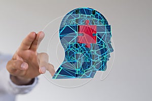 Head of a person made of jigsaw puzzles behind a person's fingers