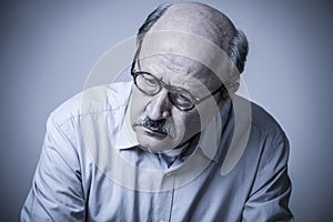 Head portrait of senior mature old man on his 60s looking sad an