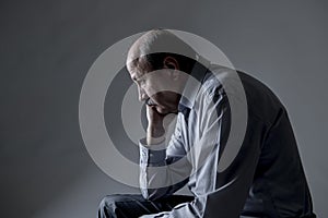 Head portrait of senior mature old man on his 60s looking sad and worried suffering pain and depression in sadness face expression