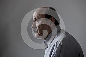 Head portrait of senior mature old man on his 60s looking sad and worried suffering pain and depression in sadness face expression