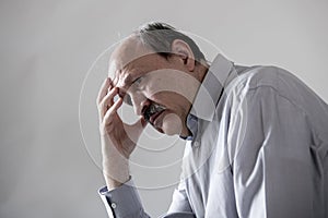 Head portrait of senior mature old man on his 60s looking sad and worried suffering pain and depression in sadness face expression