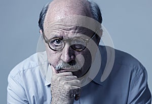 Head portrait of senior mature old man on his 70s looking sad and worried suffering Alzheimer disease