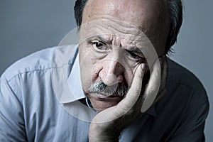 Head portrait of senior mature old man on his 70s looking sad and worried suffering Alzheimer disease