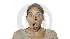 Head portrait of young happy and excited hispanic woman 30s in surprise and astonished face expression eyes and mouth wide open is