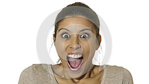 Head portrait of young happy and excited hispanic woman 30s in surprise and astonished face expression eyes and mouth wide open is