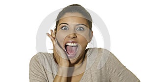 Head portrait of young happy and excited hispanic woman 30s in surprise and astonished face expression eyes and mouth wide open is