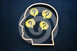 Head with question marks inside symbolizing uncertainty or curiosity. photo