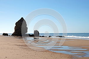 Head rock pillar at Playa de Rompeculos beach in Mazagon, Spain photo