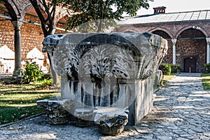 A head of the Roman column in a courtyard of the Topkapi Palace Museum, Istanbul photo