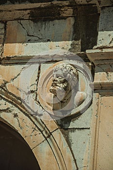 Head sculpture made of marble on the upper part of arch