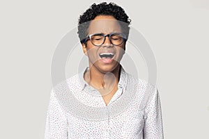 Head shot angry stressed African American woman screaming