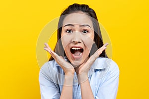 Head shot Beautiful young woman surprised facial expression, shocking, amaze isolated on yellow background.