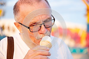 Head shot of caucasian man eating ice cream cone.