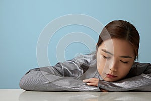 Head shot of cheerful happy asian young woman posing over blue background Isolated. Vertical portrait.