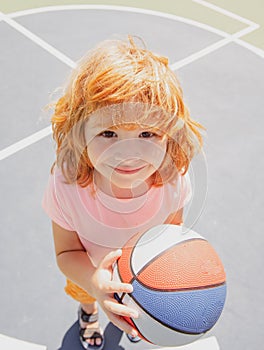 Head shot of child play basketball. Kids face, little boy portrait.