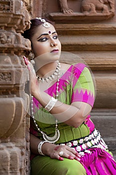 Head shot close up sad young indian traditional woman wearing traditional costume.