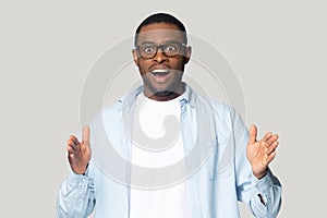 Head shot excited African American man showing big size gesture