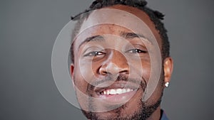 Head shot face of smiling friendly african american man looking at camera.