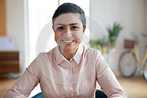 Head shot happy millennial indian businesswoman portrait.