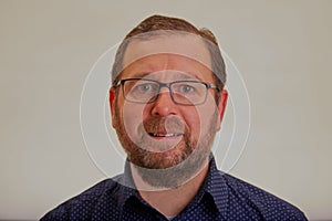 Head shot of man with glasses and beard.