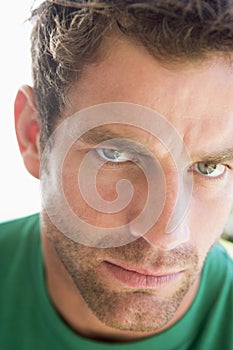 Head shot of man scowling photo