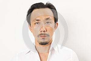 Head shot of middle aged Asian man looking at camera