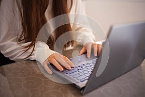 Head shot pleasant happy young woman freelancer working on computer at home. Attractive businesswoman studying online, using