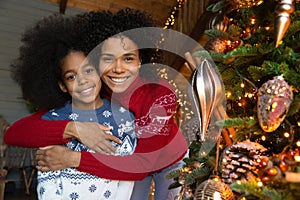 Head shot portrait African American mother and daughter celebrating Christmas