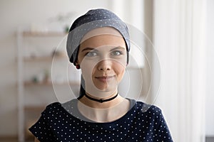 Head shot portrait attractive hairless woman wearing head scarf