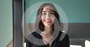 Head shot portrait beautiful Lebanese businesswoman smile looking at camera