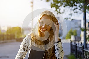 Head shot portrait of blond smiling woman walking on street