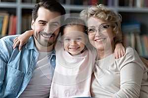 Head shot portrait of bonding smiling intergenerational family.