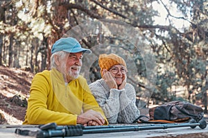Head shot portrait close up of cute couple of old middle age people having fun and enjoying together in the forest of the mountain