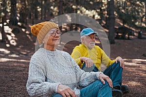 Head shot portrait close up of two old seniors middle age people meditating and relaxing in the mountain in the middle of the