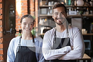 Head shot portrait of coffeehouse workers, smiling waiter and waitress