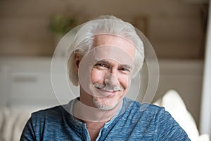 Head shot portrait of confident handsome aged man